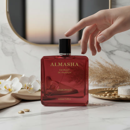 Almasha Rouge Crystal perfume in a striking red glass bottle with gold lettering. Unisex 100ml extrait de parfum.