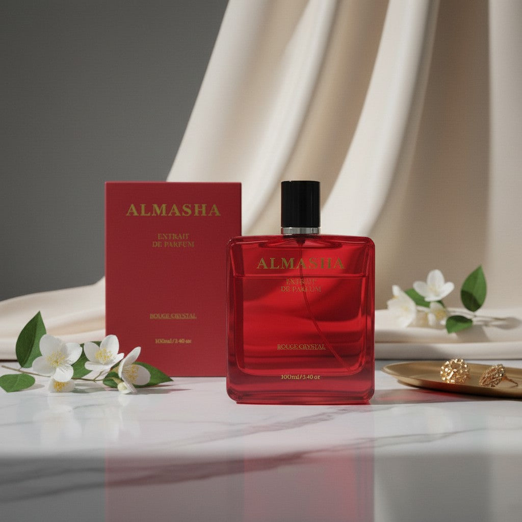 Almasha Rouge Crystal, a unisex luxury perfume in a striking red glass bottle with gold lettering. 100ml.